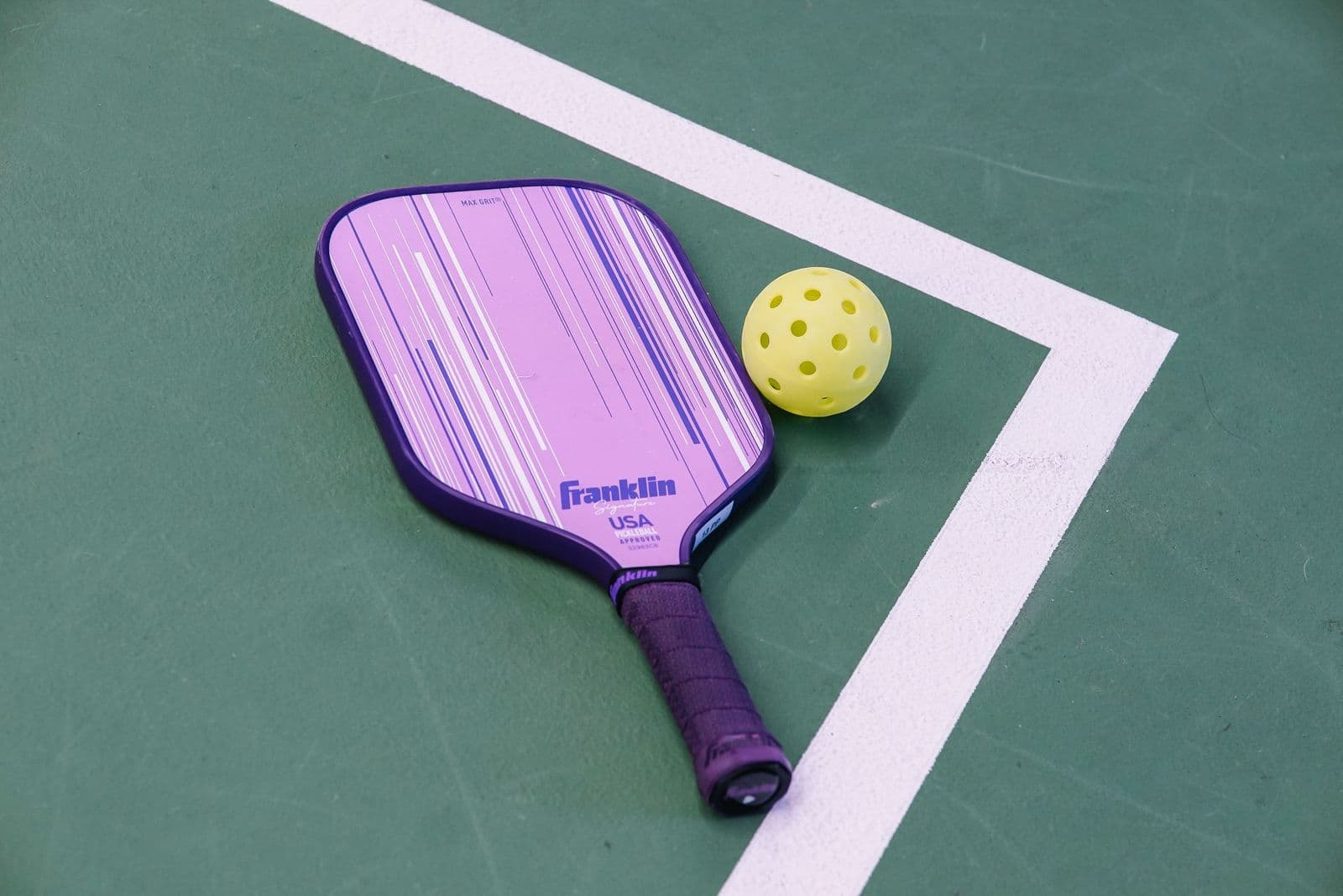 Pickleball paddle and ball on a Calgary court